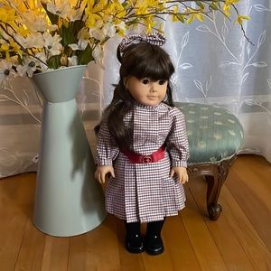 Collectible American Girl Doll - Samantha and 3 outfits as shown.